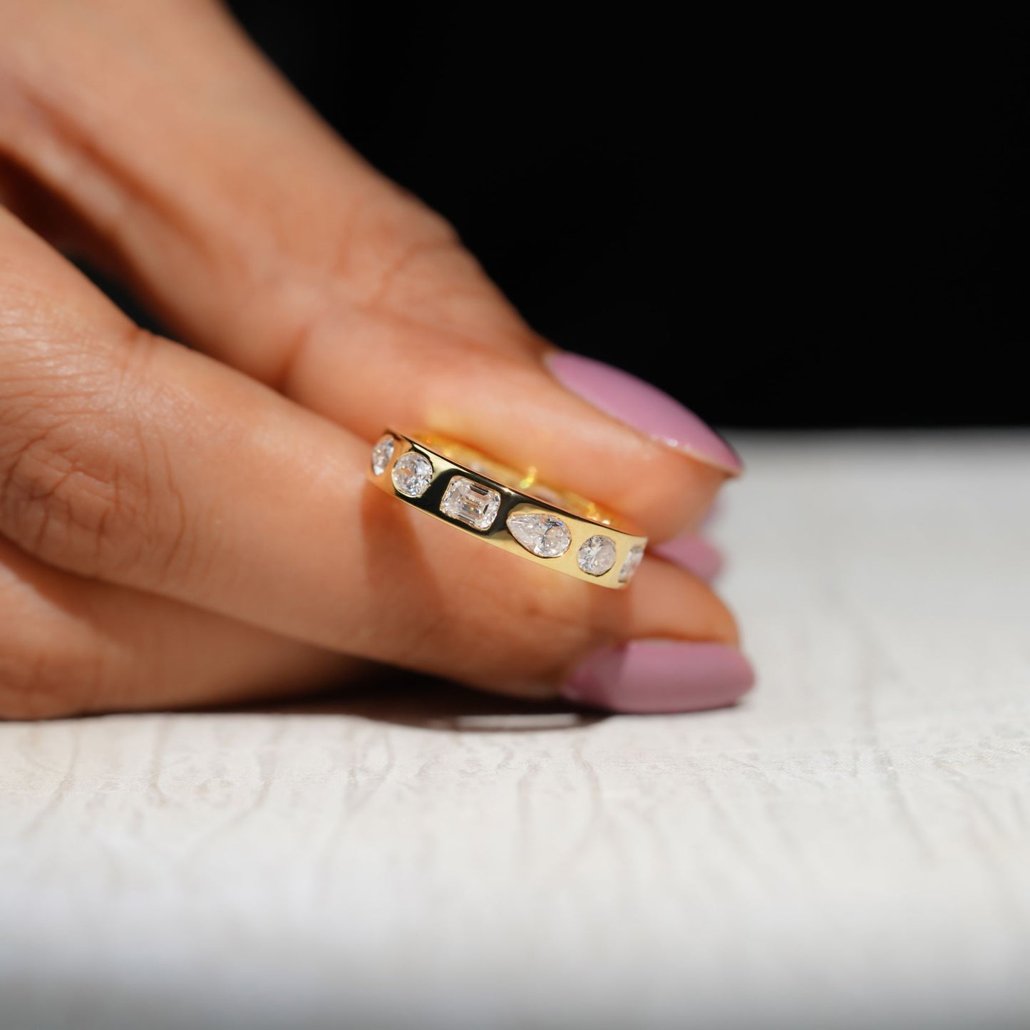 Gold Band Ring Featuring Mix Of Bezel-Set Diamonds Including Oval, Pear And Emerald Cuts Creating A Modern And Luxurious Multi-Shape Design