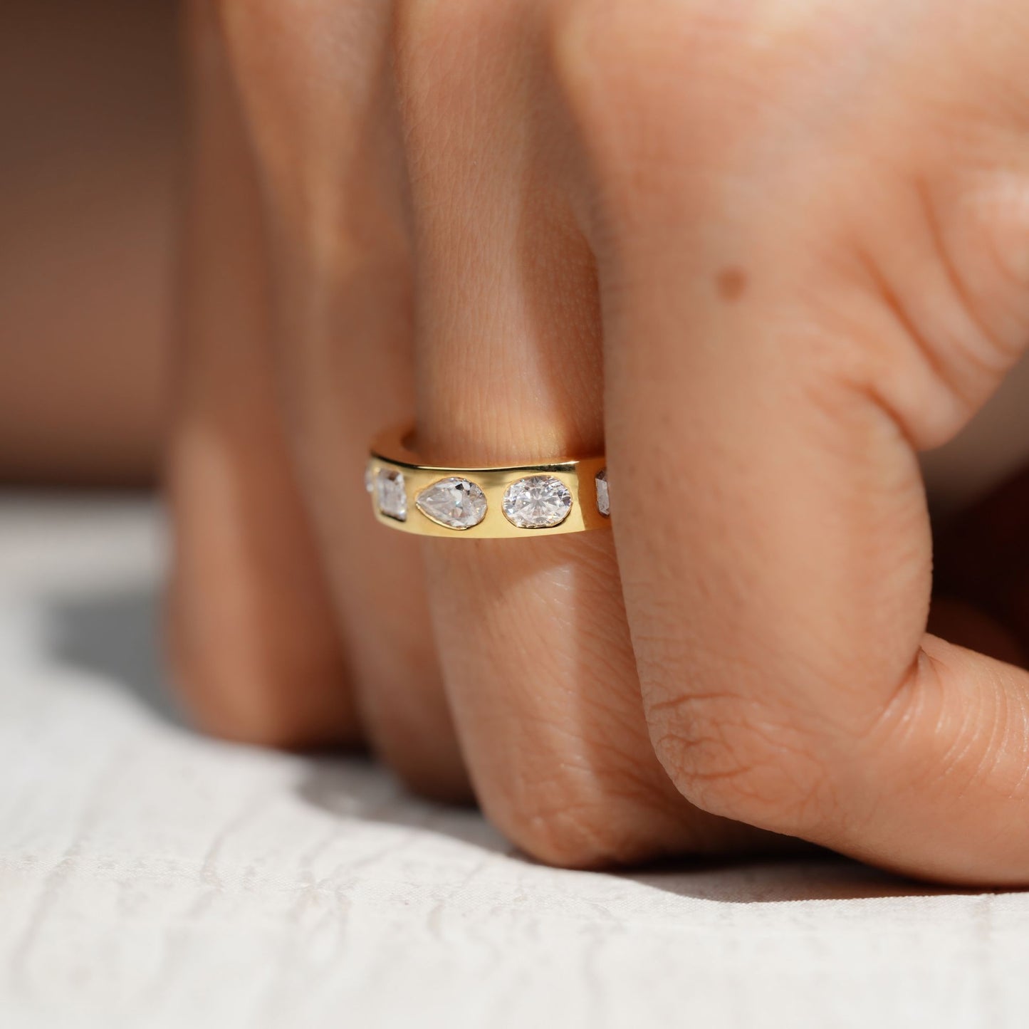 Gold Band Ring Featuring Mix Of Bezel-Set Diamonds Including Oval, Pear And Emerald Cuts Creating A Modern And Luxurious Multi-Shape Design