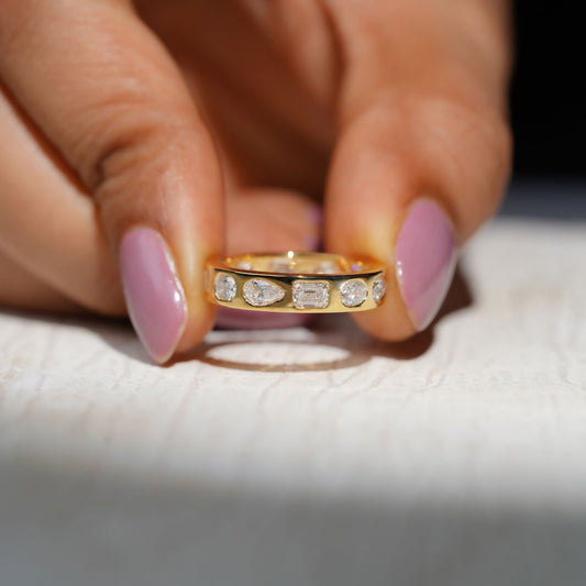 Gold Band Ring Featuring Mix Of Bezel-Set Diamonds Including Oval, Pear And Emerald Cuts Creating A Modern And Luxurious Multi-Shape Design