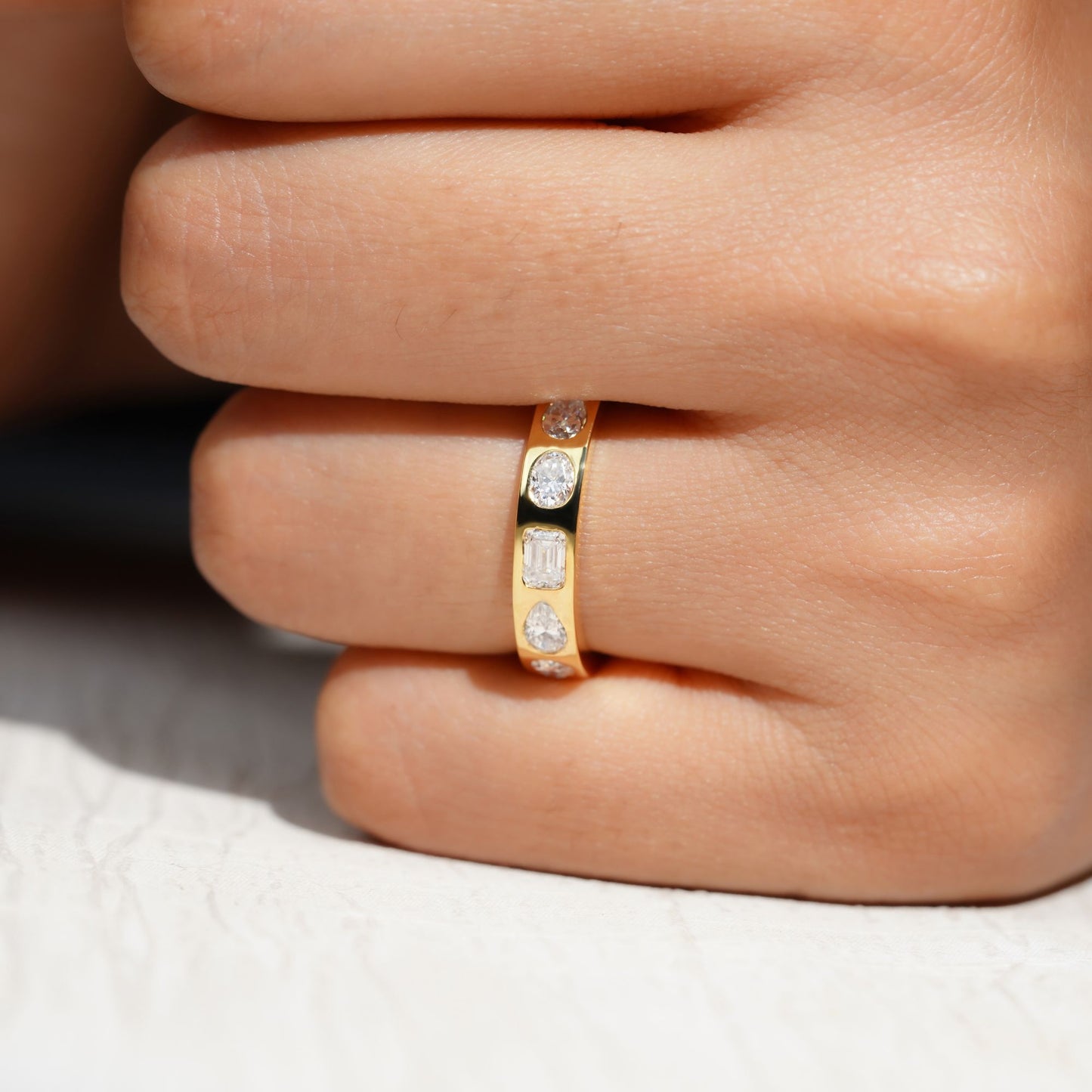 Gold Band Ring Featuring Mix Of Bezel-Set Diamonds Including Oval, Pear And Emerald Cuts Creating A Modern And Luxurious Multi-Shape Design
