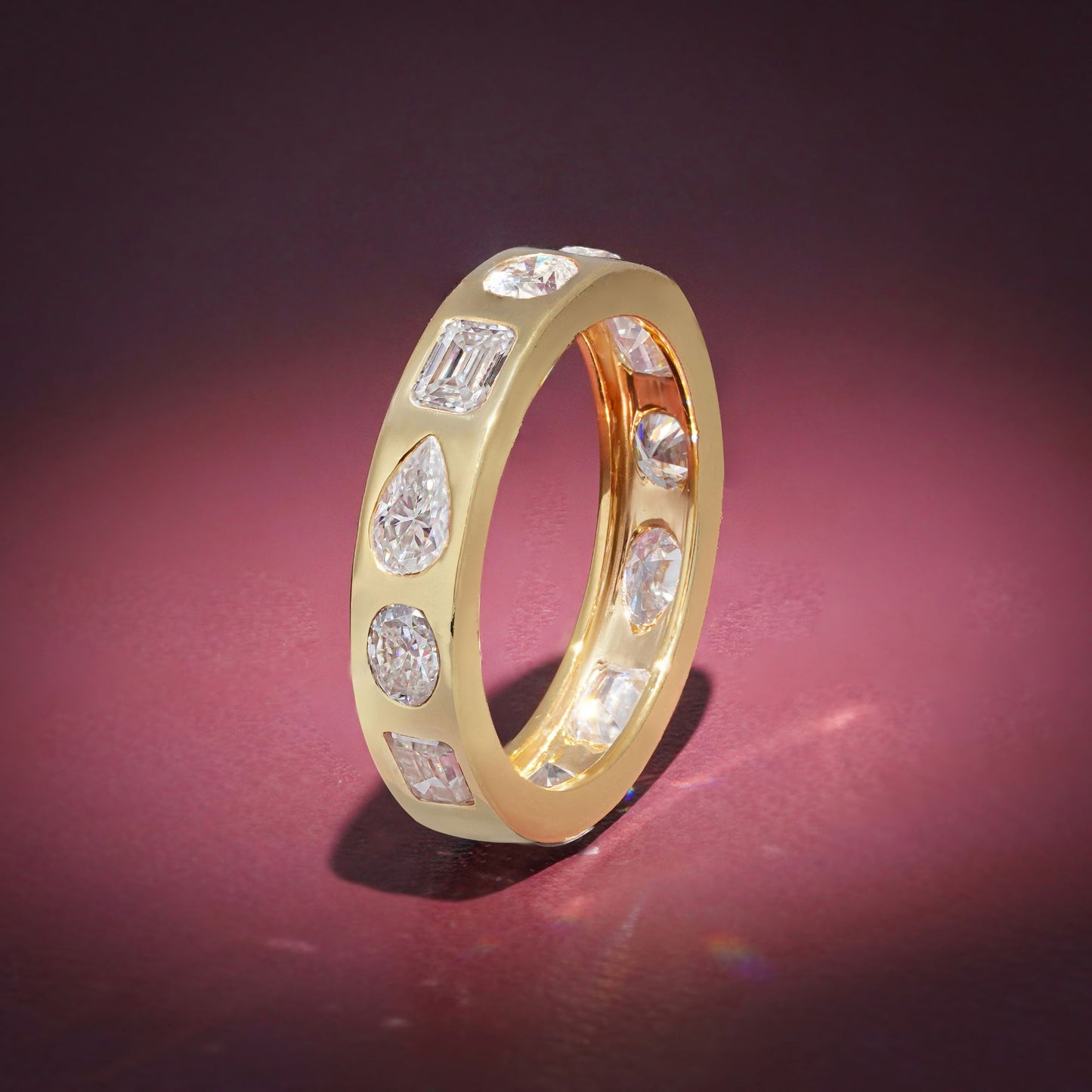 Gold Band Ring Featuring Mix Of Bezel-Set Diamonds Including Oval, Pear And Emerald Cuts Creating A Modern And Luxurious Multi-Shape Design