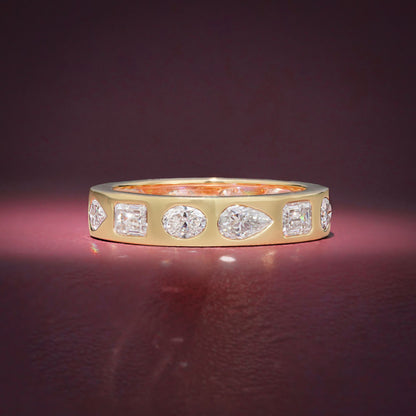 Gold Band Ring Featuring Mix Of Bezel-Set Diamonds Including Oval, Pear And Emerald Cuts Creating A Modern And Luxurious Multi-Shape Design