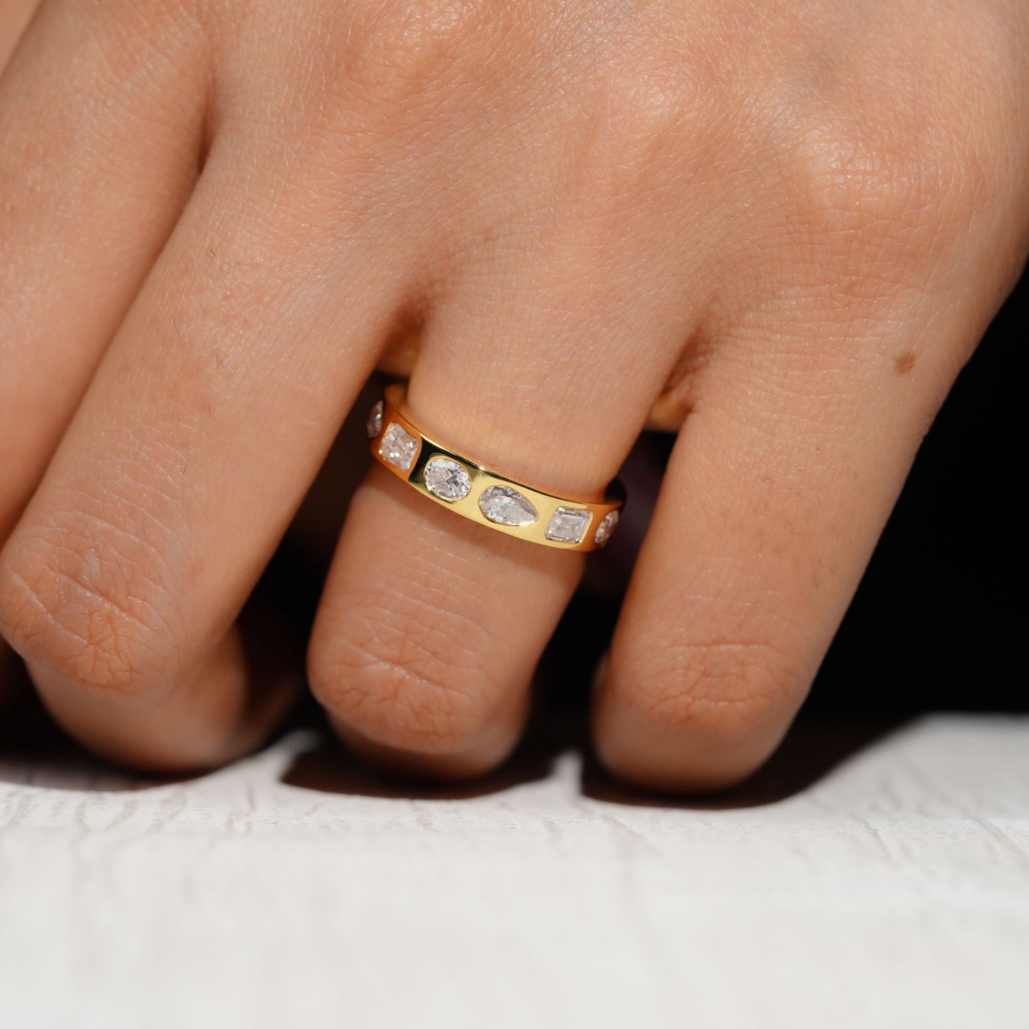 Gold Band Ring Featuring Mix Of Bezel-Set Diamonds Including Oval, Pear And Emerald Cuts Creating A Modern And Luxurious Multi-Shape Design