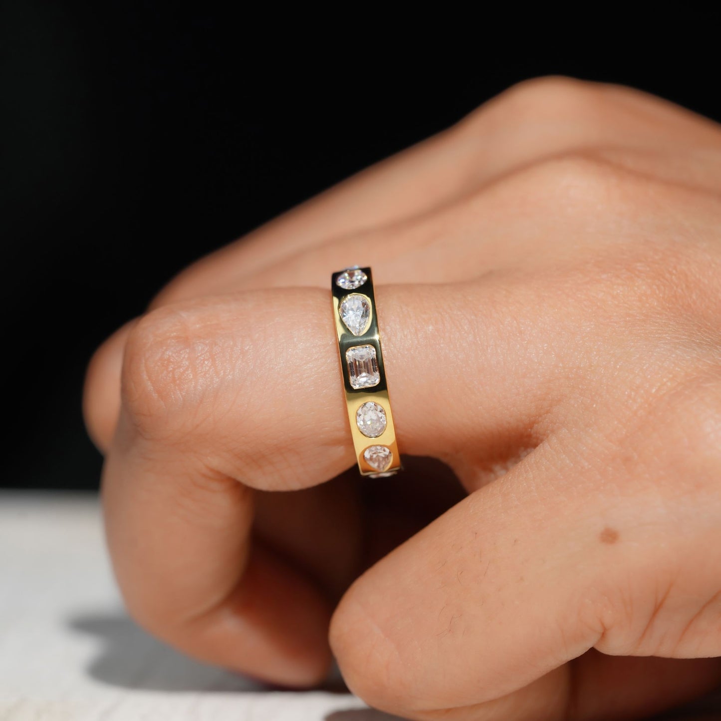 Gold Band Ring Featuring Mix Of Bezel-Set Diamonds Including Oval, Pear And Emerald Cuts Creating A Modern And Luxurious Multi-Shape Design