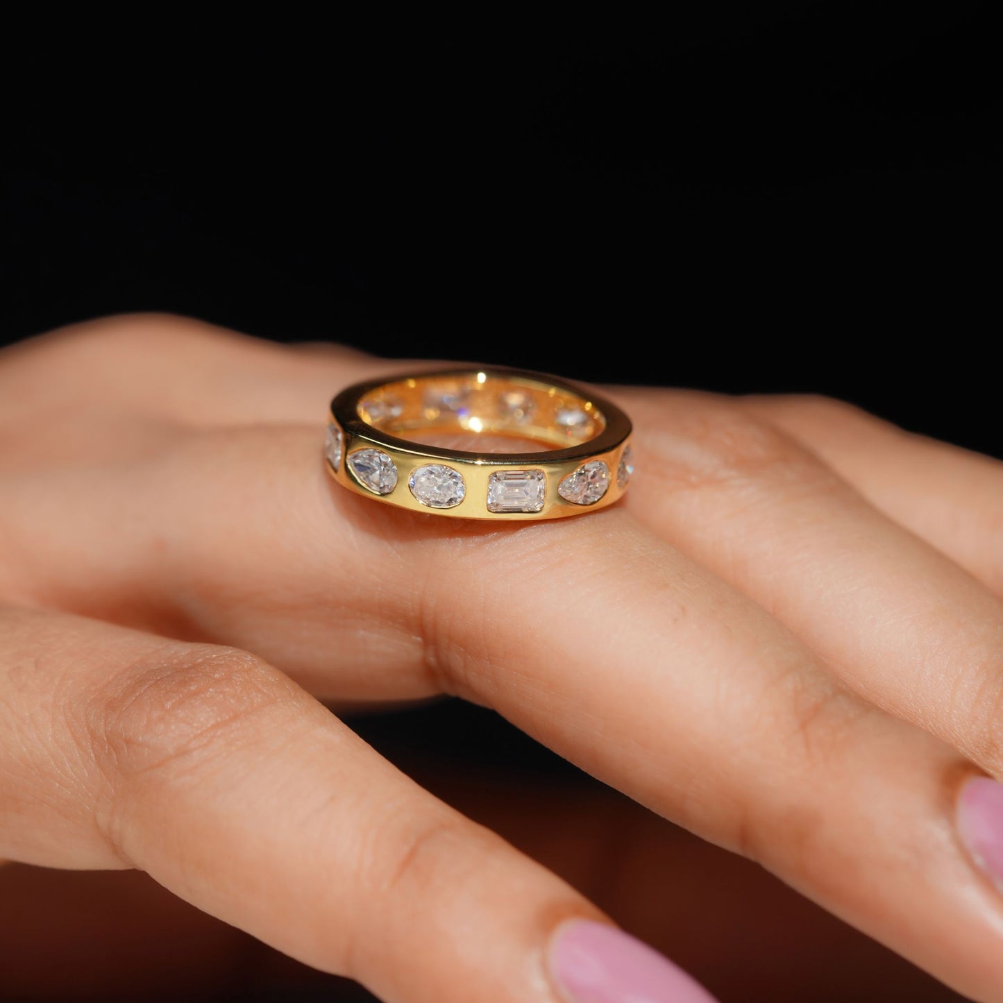 Gold Band Ring Featuring Mix Of Bezel-Set Diamonds Including Oval, Pear And Emerald Cuts Creating A Modern And Luxurious Multi-Shape Design